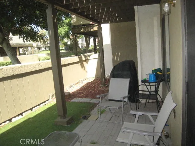 a view of a balcony with chair and table