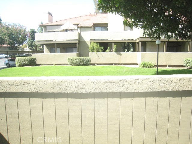 10151 Arrow Route, Unit 11 Rancho Cucamonga, CA 91730 - Photo 17 of 28 a view of a house with a yard and potted plants