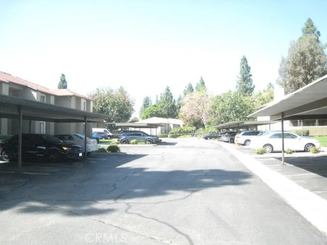 a view of a city street with a car parked on the road