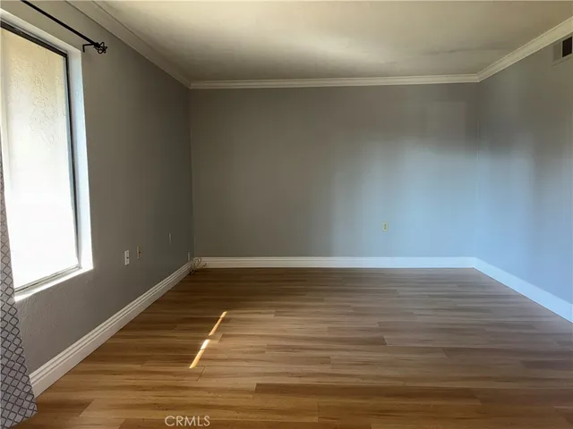 a view of a room with wooden floor and window