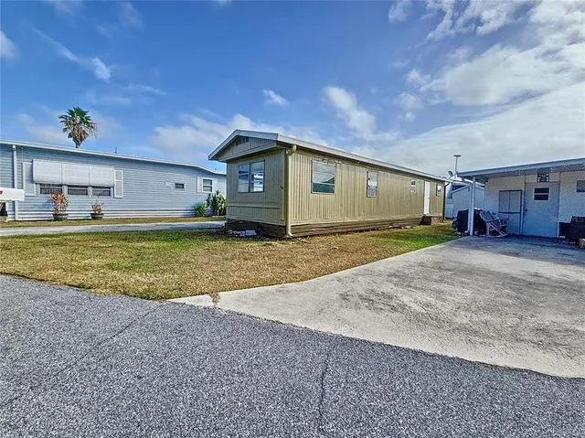 a view of a house with a yard and garage