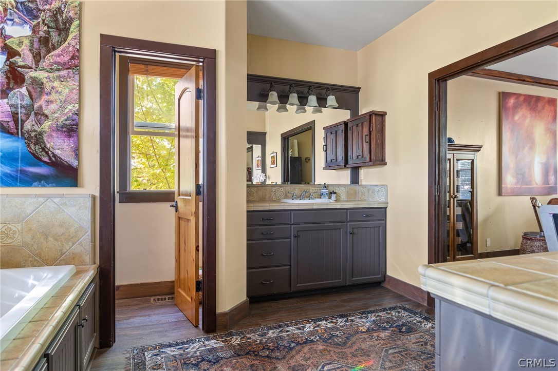 1224 Halifax Drive Lake Arrowhead, CA 92352 - Photo 18 of 35 a bathroom with a granite countertop sink and a mirror