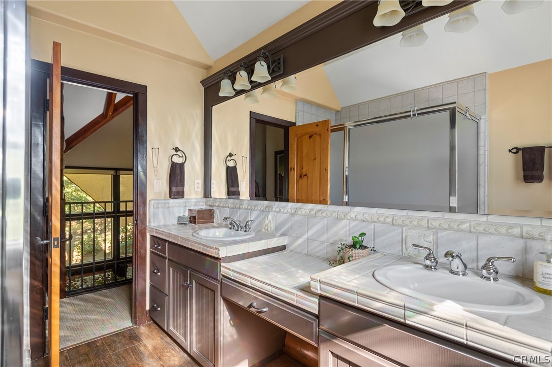 1224 Halifax Drive Lake Arrowhead, CA 92352 - Photo 22 of 35 a en suite bathroom with a granite countertop sink and a mirror