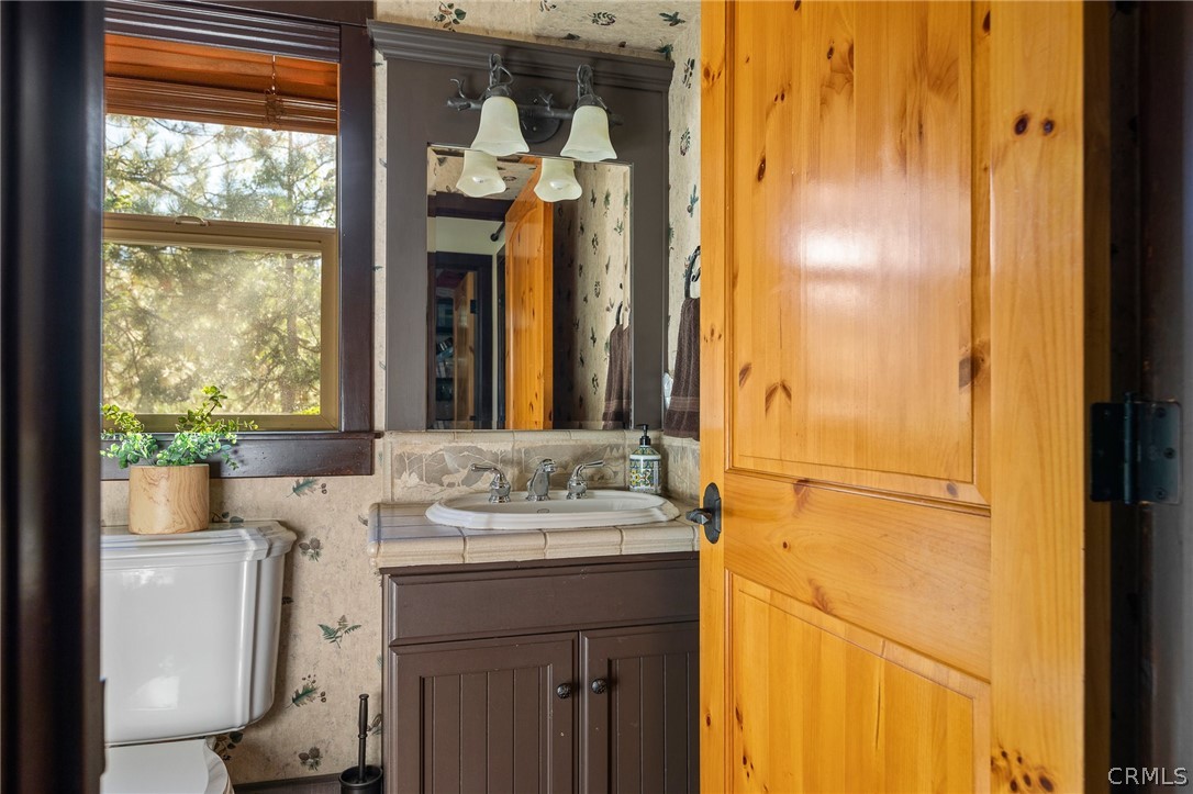 1224 Halifax Drive Lake Arrowhead, CA 92352 - Photo 27 of 35 a bathroom with a sink vanity and a mirror
