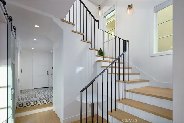 a view of entryway and hall with wooden floor