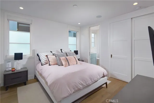 a bedroom with a bed and a night stand