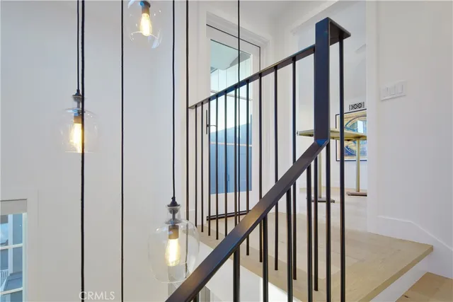 a view of staircase with railing and white walls