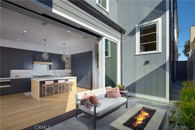 a living room with stainless steel appliances kitchen island granite countertop a stove and a sink