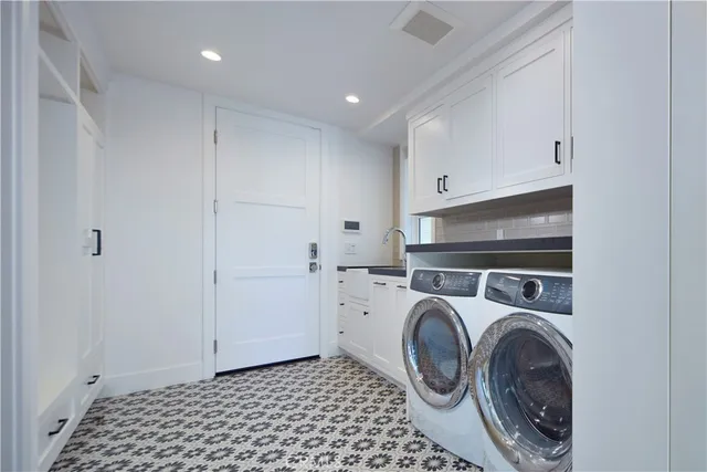 a utility room with sink dryer and washer
