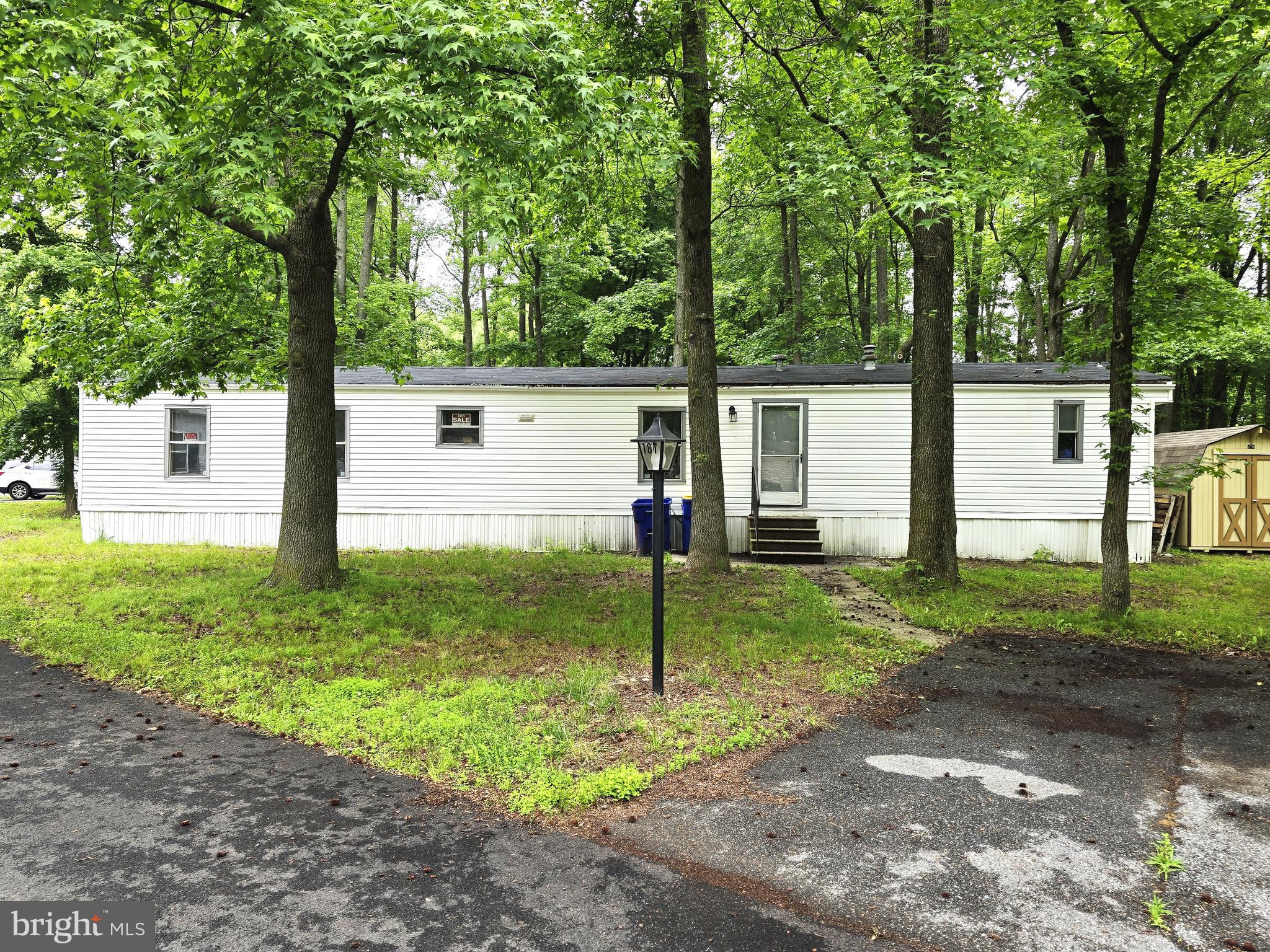 a view of a house with backyard and a tree