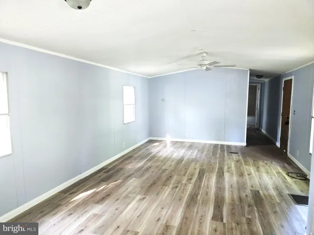 a kitchen with a sink and wooden floor