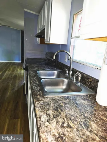 a view of a kitchen with a sink and cabinets