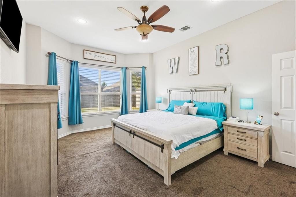 868 Valley Ridge Road Burleson, TX 76028 - Photo 18 of 40 a bed room with a bed and a flat tv screen