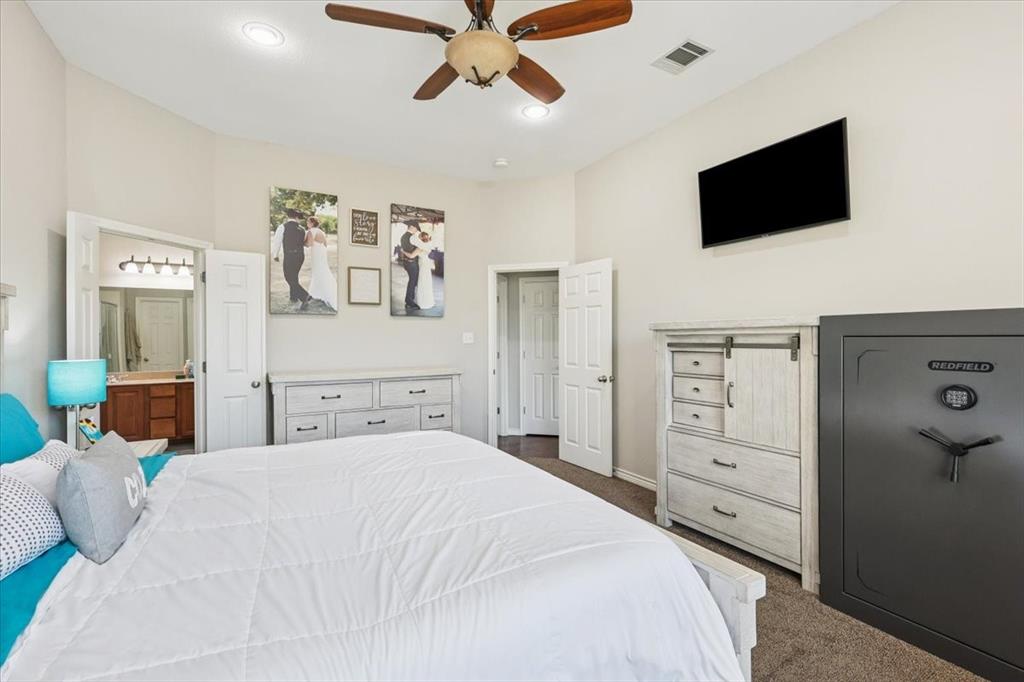 868 Valley Ridge Road Burleson, TX 76028 - Photo 19 of 40 a bedroom with a bed and a flat screen tv