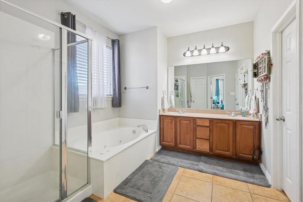 868 Valley Ridge Road Burleson, TX 76028 - Photo 20 of 40 a spacious bathroom with a tub sink and mirror