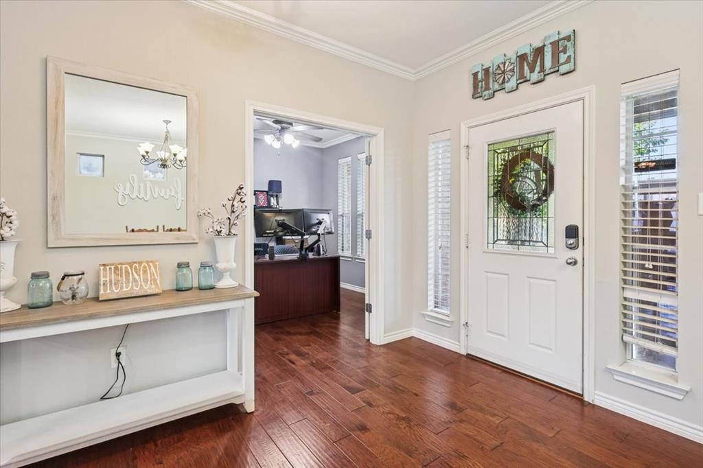 868 Valley Ridge Road Burleson, TX 76028 - Photo 2 of 40 a room with a wooden floor and mirror