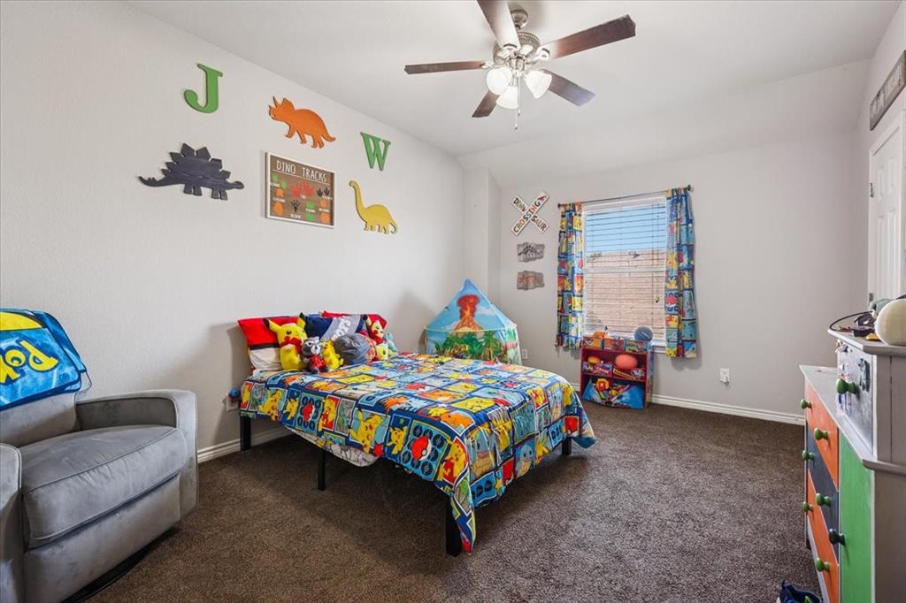 868 Valley Ridge Road Burleson, TX 76028 - Photo 26 of 40 a bedroom with a bed and a couch