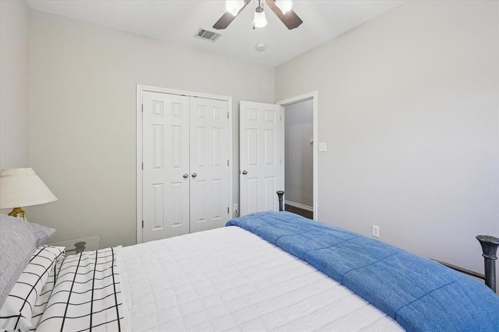 868 Valley Ridge Road Burleson, TX 76028 - Photo 31 of 40 a bedroom with a bed and a chandelier