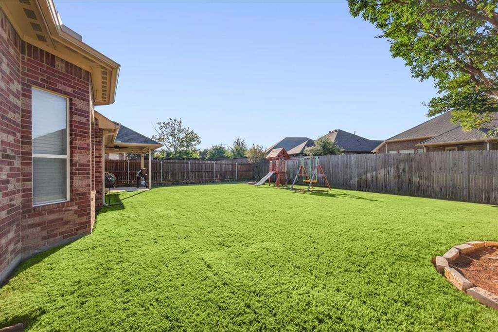 868 Valley Ridge Road Burleson, TX 76028 - Photo 36 of 40 a view of a backyard with a garden