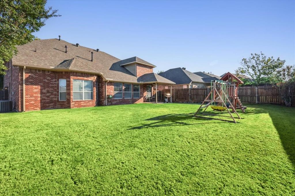 868 Valley Ridge Road Burleson, TX 76028 - Photo 37 of 40 a view of a house with a yard and potted plants