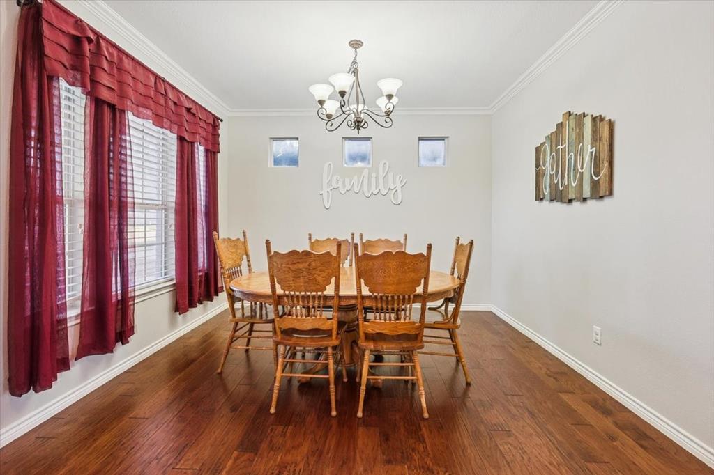 868 Valley Ridge Road Burleson, TX 76028 - Photo 4 of 40 a view of a dining room with furniture wooden floor and chandelier