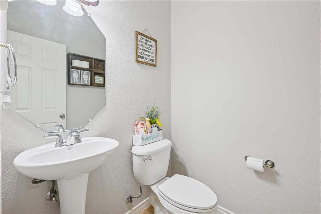 868 Valley Ridge Road Burleson, TX 76028 - Photo 6 of 40 a bathroom with a sink mirror and toilet