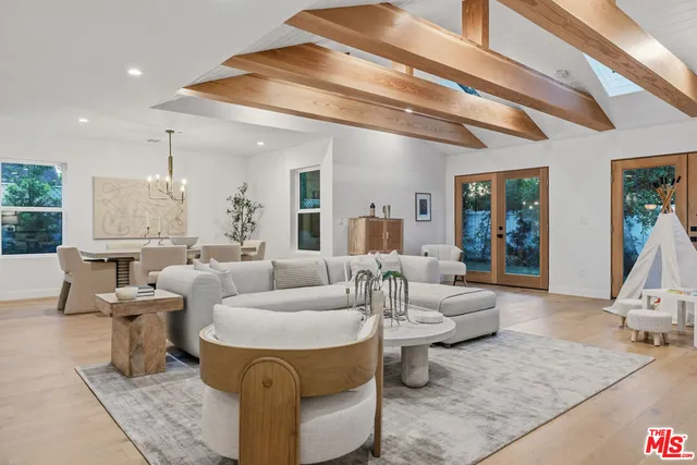 a living room with furniture and a chandelier
