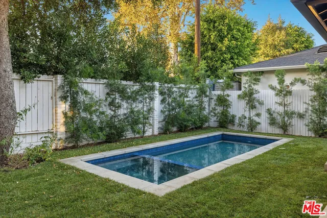 a view of a backyard with swimming pool