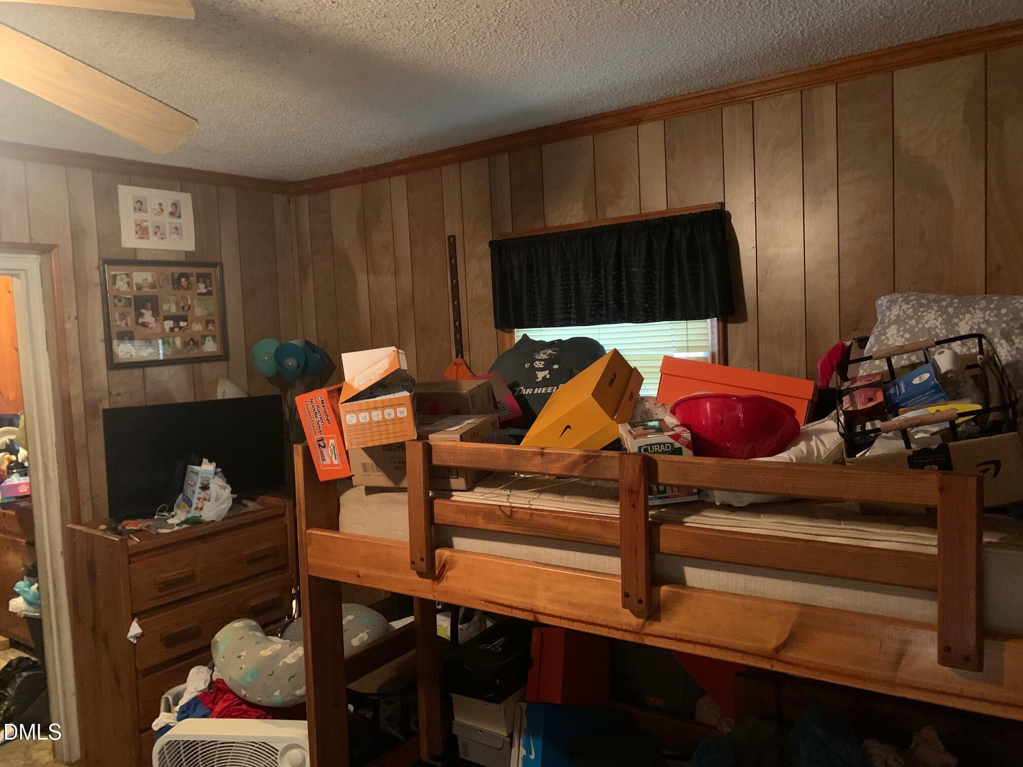 438 Dudley Street Burlington, NC 27217 - Photo 20 of 33 a bedroom with a bed and wooden floor