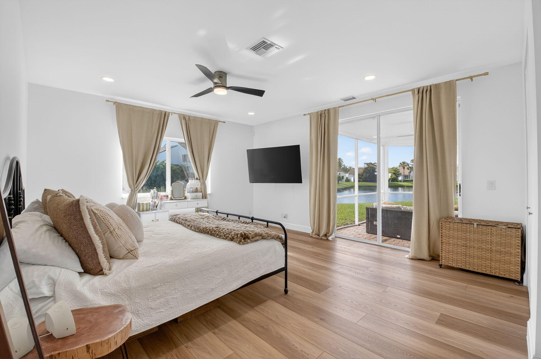 17108 Newport Club Drive Boca Raton, FL 33496 - Photo 10 of 39 a spacious bedroom with a bed and large mirror with wooden floor