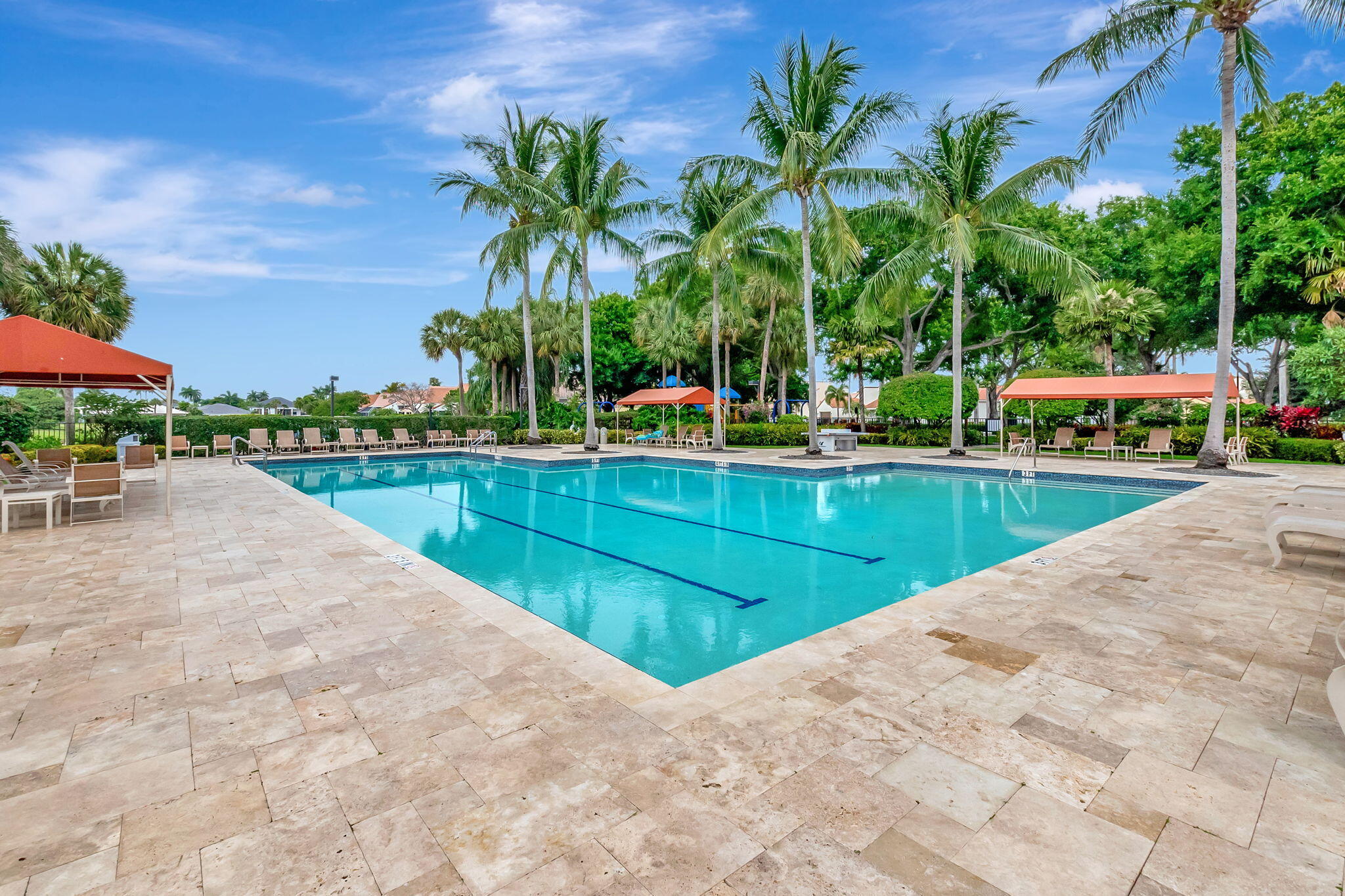 17108 Newport Club Drive Boca Raton, FL 33496 - Photo 27 of 39 a view of a swimming pool with a lawn chairs under an umbrella