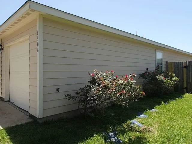 a backyard of a house with a garden