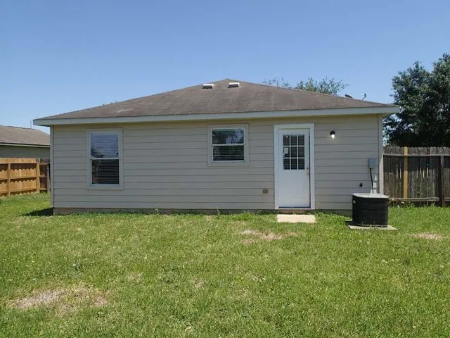 a backyard of a house with table and chairs