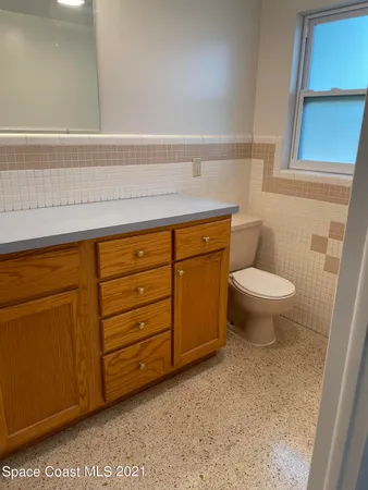 a bathroom with a sink a toilet and vanity