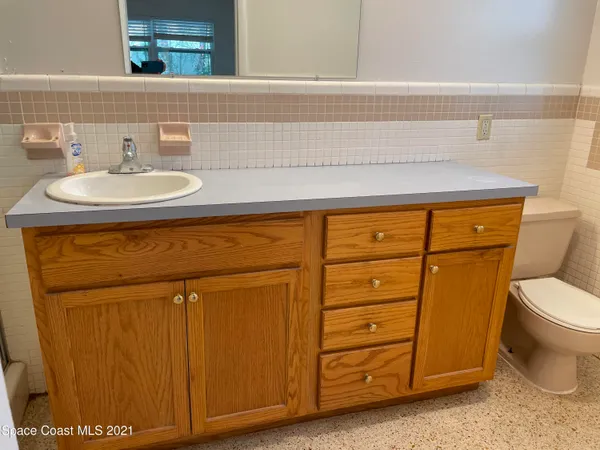 a bathroom with a shower sink and mirror