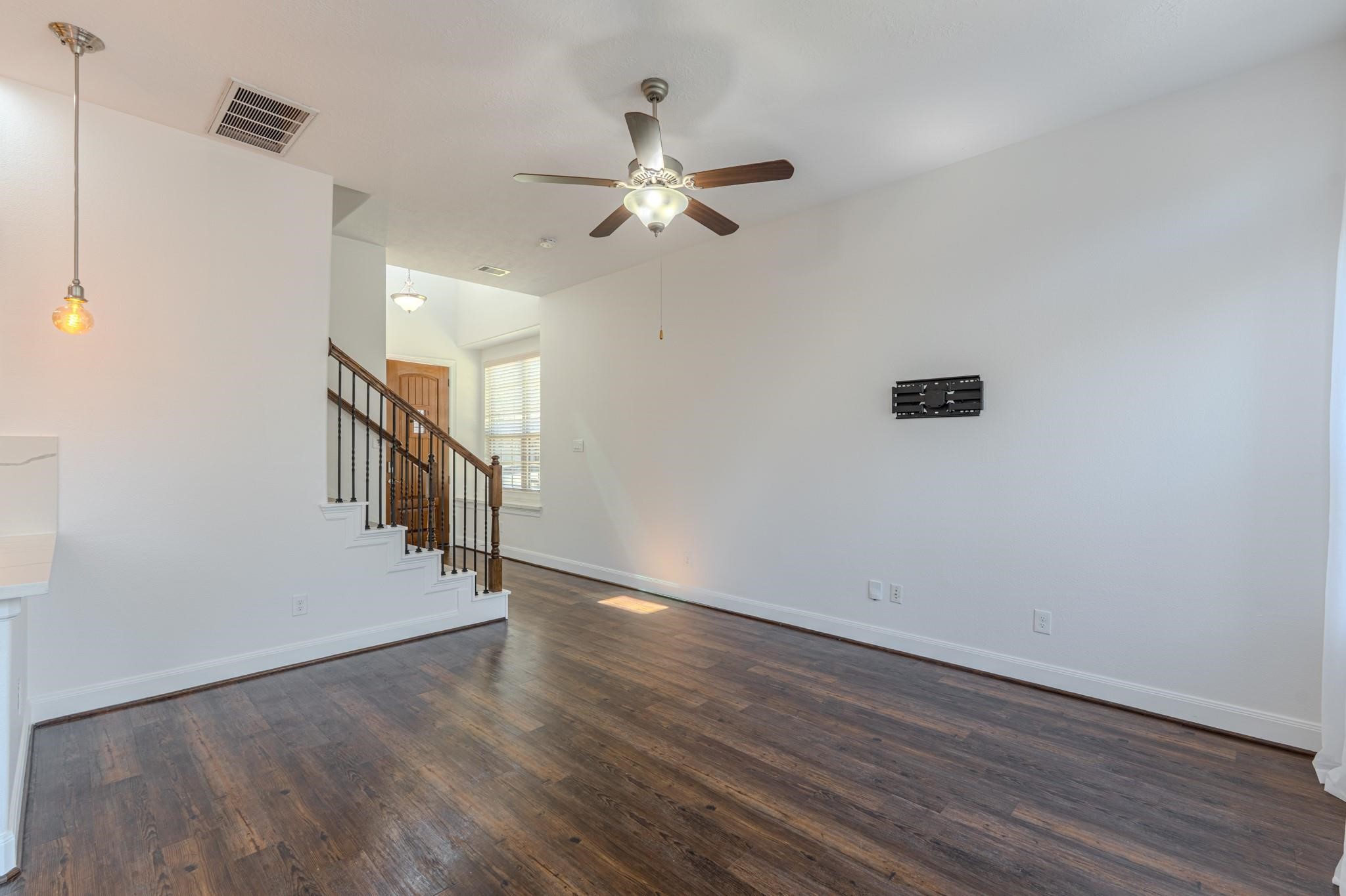 58 Aventura Place Spring, TX 77389 - Photo 11 of 23 a view of a hallway with wooden floor and staircase