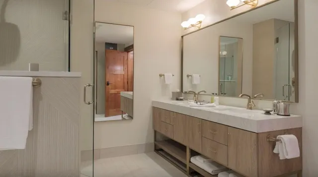 a bathroom with a double vanity sink and mirror