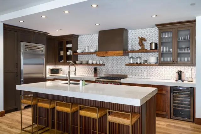 a kitchen with stainless steel appliances a sink and a refrigerator