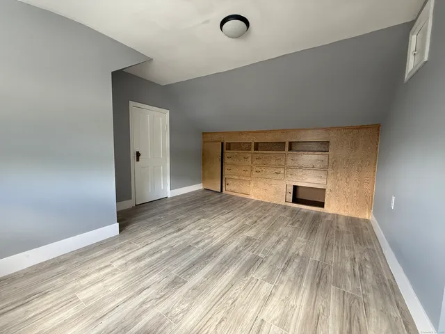 a view of empty room with kitchen and sink