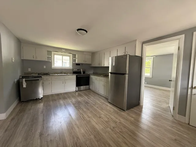 a kitchen with a refrigerator and a stove top oven