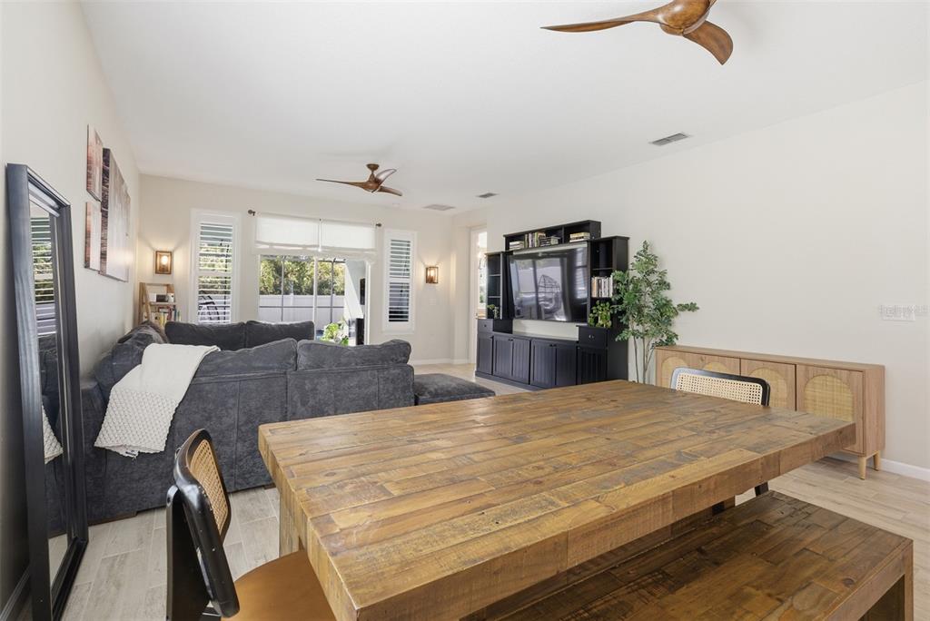 5232 Bentgrass Way Bradenton, FL 34211 - Photo 12 of 57 a living room with kitchen island furniture and a kitchen view