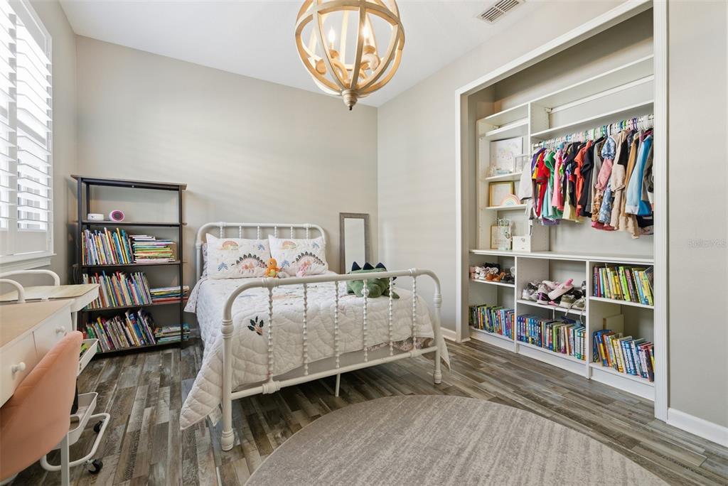 5232 Bentgrass Way Bradenton, FL 34211 - Photo 22 of 57 a bedroom with a bed and a book shelf