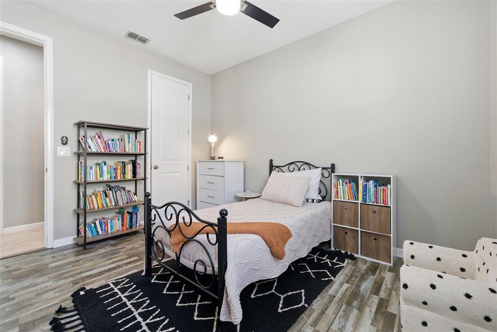 5232 Bentgrass Way Bradenton, FL 34211 - Photo 24 of 57 a bedroom with furniture and a book shelf