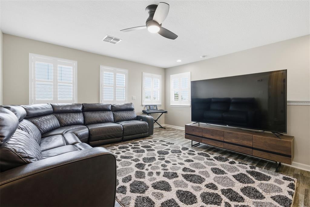 5232 Bentgrass Way Bradenton, FL 34211 - Photo 28 of 57 a living room with furniture and a flat screen tv