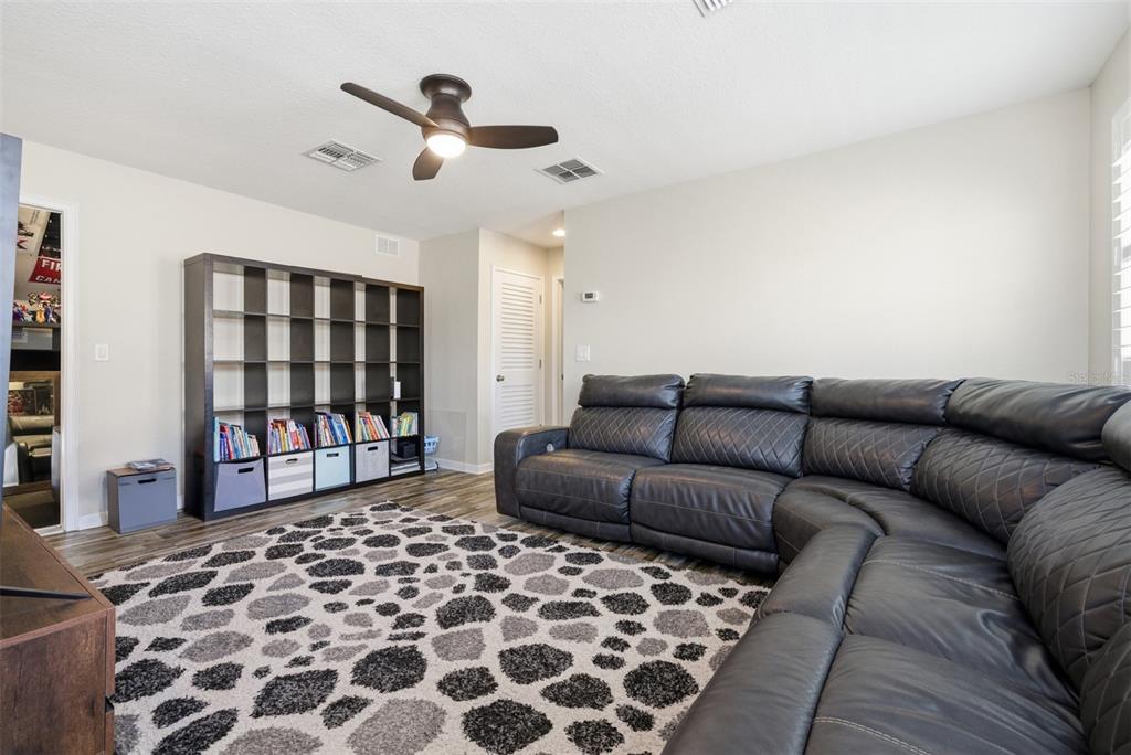 5232 Bentgrass Way Bradenton, FL 34211 - Photo 29 of 57 a living room with a couch and a bookshelf