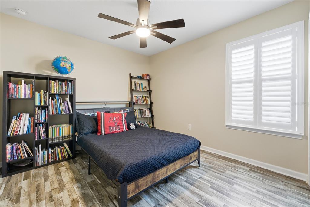 5232 Bentgrass Way Bradenton, FL 34211 - Photo 31 of 57 a bedroom with furniture and a book shelf