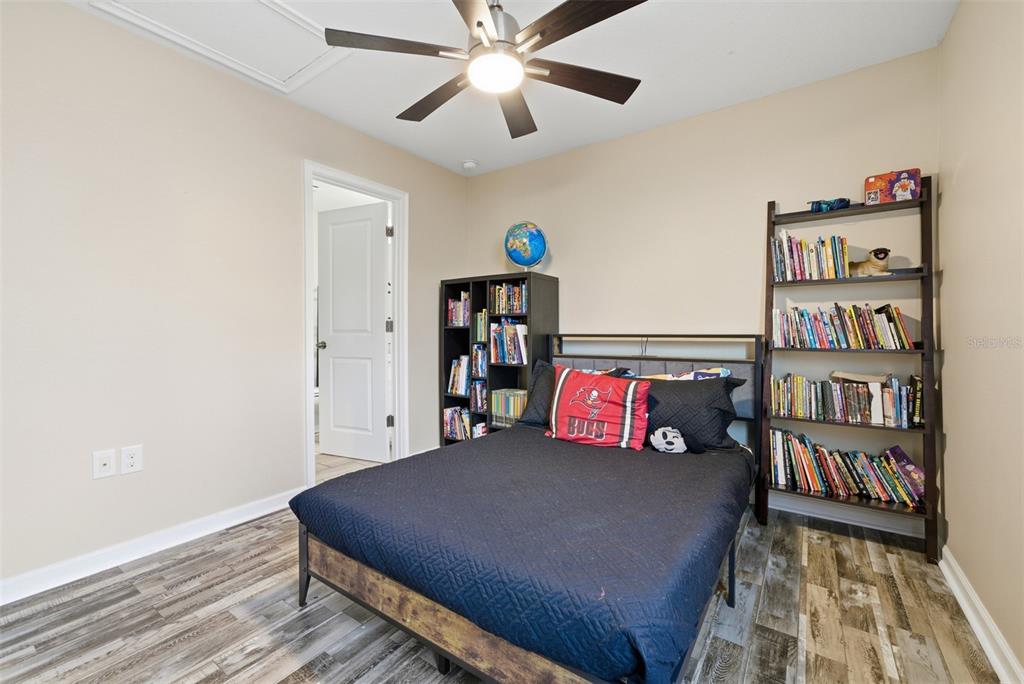 5232 Bentgrass Way Bradenton, FL 34211 - Photo 32 of 57 a bedroom with a bed and a bookshelf