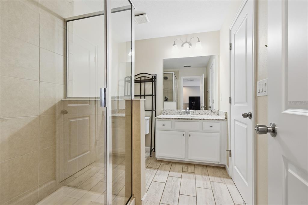 5232 Bentgrass Way Bradenton, FL 34211 - Photo 33 of 57 a bathroom with a shower and a sink