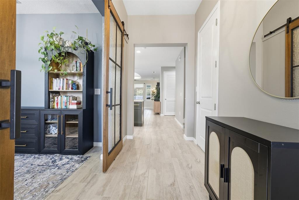 5232 Bentgrass Way Bradenton, FL 34211 - Photo 4 of 57 a view of a hallway with wooden floor and a living room
