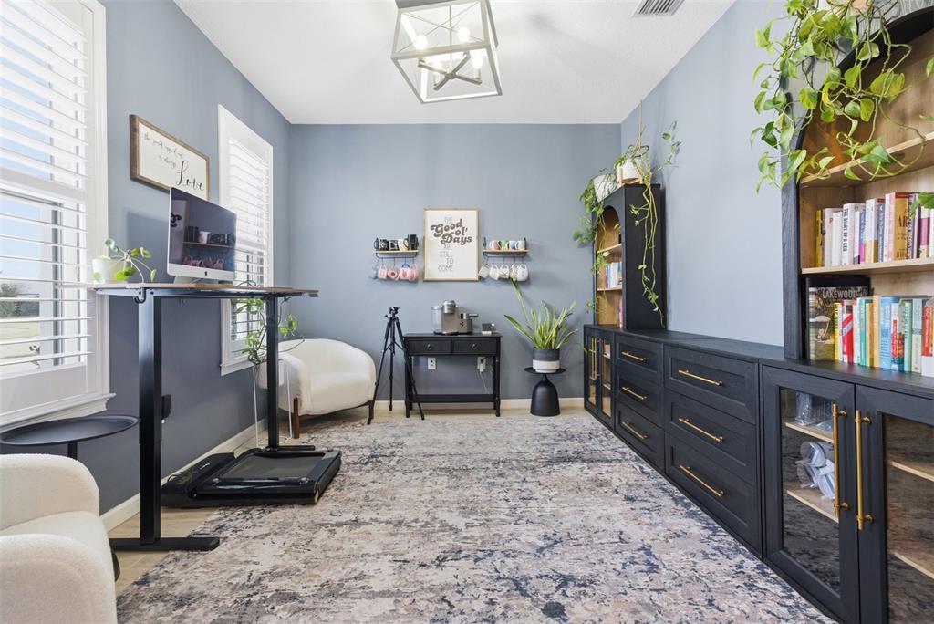 5232 Bentgrass Way Bradenton, FL 34211 - Photo 5 of 57 a living room with lots of furniture and a book shelf